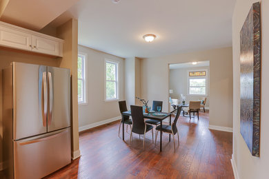 Inspiration for a mid-sized timeless medium tone wood floor kitchen/dining room combo remodel in Baltimore with beige walls and no fireplace