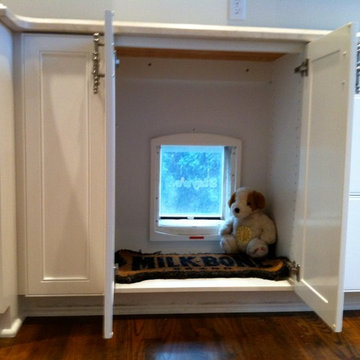 DOGGIE DOOR, HIDDEN IN CABINET, GOES OUT TO DOG RUN