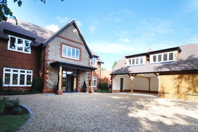Inspiration for a red and large detached house in Surrey with three floors, a pitched roof and a tiled roof.