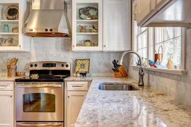 Enclosed kitchen - mid-sized traditional u-shaped medium tone wood floor enclosed kitchen idea in Birmingham with a single-bowl sink, recessed-panel cabinets, white cabinets, granite countertops, white backsplash, ceramic backsplash, stainless steel appliances and no island