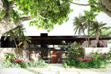 Huge minimalist entryway photo in Miami with a medium wood front door
