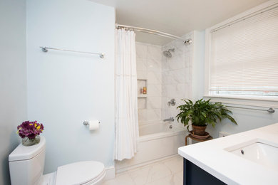 Example of a mid-sized minimalist master white tile and ceramic tile ceramic tile and white floor bathroom design in Providence with beaded inset cabinets, blue cabinets, a one-piece toilet, blue walls, an undermount sink and tile countertops