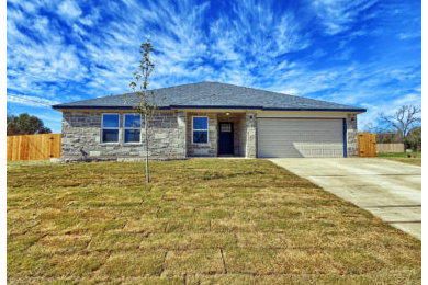 Beige one-story stone house exterior photo in Austin with a shingle roof