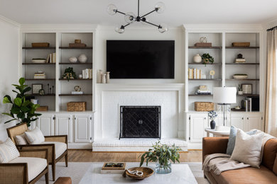 Living room - transitional light wood floor and brown floor living room idea in DC Metro with white walls and a brick fireplace