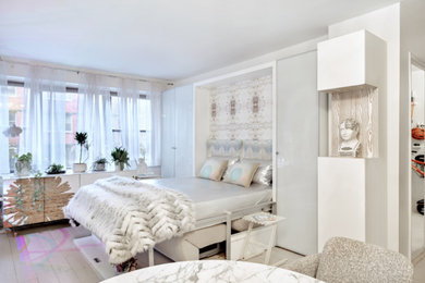 This is an example of a small transitional bedroom in New York with white walls, ceramic floors, grey floor and wallpaper.