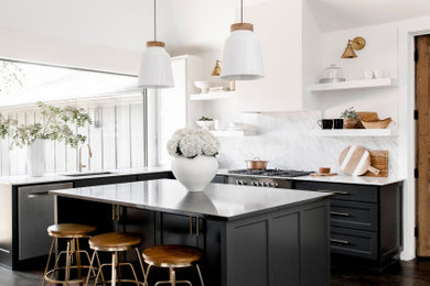 Open concept kitchen - mid-sized transitional l-shaped dark wood floor and brown floor open concept kitchen idea in Other with an undermount sink, shaker cabinets, black cabinets, marble countertops, white backsplash, marble backsplash, stainless steel appliances, an island and white countertops