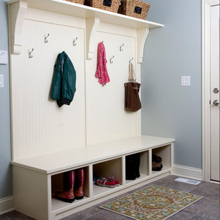 Mid-sized arts and crafts mudroom in Chicago with blue walls, porcelain floors, a single front door, a white front door and grey floor.