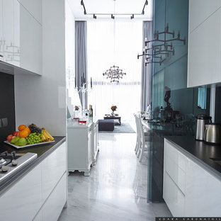 Small contemporary kitchen pantry ideas - Example of a small trendy u-shaped marble floor and white floor kitchen pantry design in Singapore with a drop-in sink, flat-panel cabinets, white cabinets, granite countertops, black backsplash, stone slab backsplash, stainless steel appliances and no island