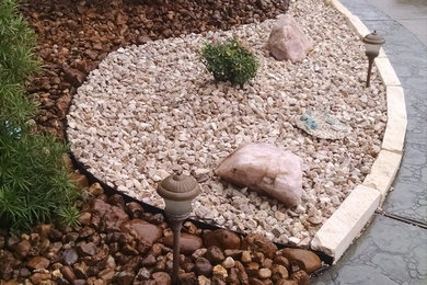 Inspiration for a mid-sized traditional front yard mulch driveway in Houston.