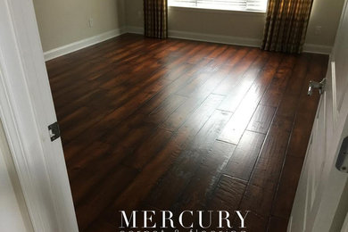Inspiration for a small timeless guest medium tone wood floor and brown floor bedroom remodel in Jacksonville with beige walls