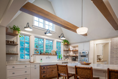 Inspiration for a large country eat-in kitchen in Cincinnati with a farmhouse sink, recessed-panel cabinets, white cabinets, granite benchtops, stainless steel appliances, light hardwood floors, with island, beige floor, white benchtop and vaulted.