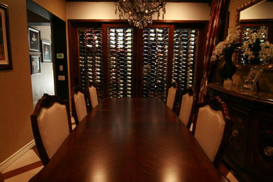 Wine cellar - mid-sized contemporary ceramic tile wine cellar idea in Other with display racks
