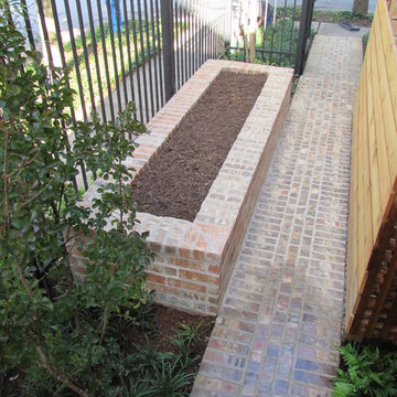 High function in a small side yard! Pergola, raised bed, mirrored wall, fountain