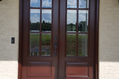Inspiration for a mid-sized entryway remodel in Raleigh with a dark wood front door