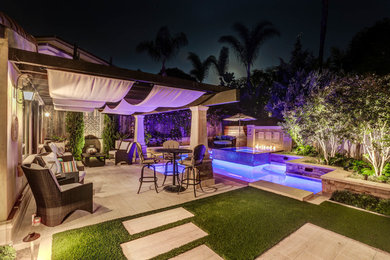 Mid-sized contemporary backyard custom-shaped pool in Orange County.