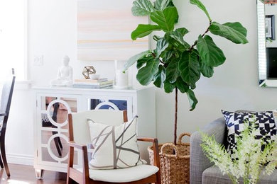 Example of a small 1960s open concept medium tone wood floor family room design in Vancouver with white walls