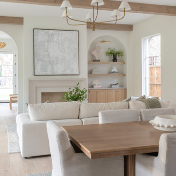 Great room with wood beams, plaster fireplace, and arched built-ins