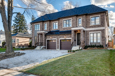 Transitional brown brick exterior home photo in Toronto