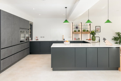 This is an example of a contemporary u-shaped kitchen/diner in Other with a built-in sink, flat-panel cabinets, black cabinets, quartz worktops and white worktops.