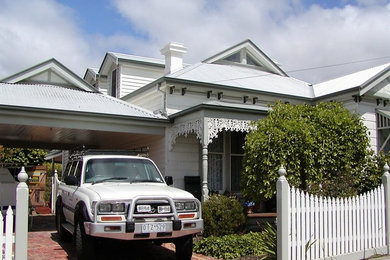 This is an example of a traditional white exterior in Melbourne with wood siding.