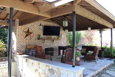 Large transitional backyard stone patio photo in Dallas with a fire pit and a gazebo
