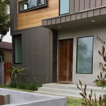 Mar Vista Magic saved Bottle Palms reflect in the entry window.