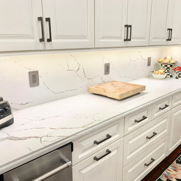 Ivory White Kitchen With Marble Look Quartz Counters and Splash
