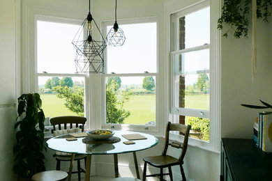 Inspiration for a small contemporary kitchen/dining room in Cambridgeshire with white walls and white floors.