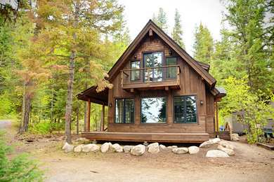 Example of a mid-sized arts and crafts brown two-story wood exterior home design in Boise with a mixed material roof