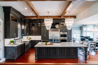 Inspiration for a mid-sized contemporary galley medium tone wood floor enclosed kitchen remodel in Cedar Rapids with an undermount sink, shaker cabinets, medium tone wood cabinets, granite countertops, white backsplash, granite backsplash, stainless steel appliances and an island