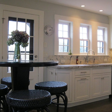 Transitional kitchen with tall table and Bianco Romano granite counters