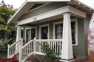 Photo of a mid-sized arts and crafts one-storey green exterior in San Diego with vinyl siding.