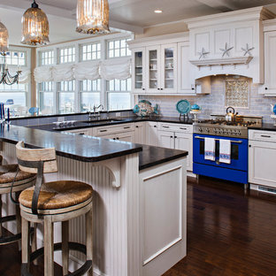 Design ideas for a large transitional u-shaped eat-in kitchen in Other with an undermount sink, recessed-panel cabinets, white cabinets, granite benchtops, blue splashback, subway tile splashback, stainless steel appliances, dark hardwood floors, blue benchtop and coffered.