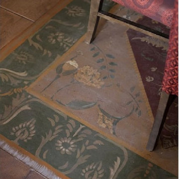 Mural painted on the floor of a restaurant of a rug.