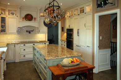 Inspiration for a large timeless u-shaped ceramic tile eat-in kitchen remodel in Toronto with a farmhouse sink, beaded inset cabinets, distressed cabinets, quartz countertops, beige backsplash, subway tile backsplash, paneled appliances and an island