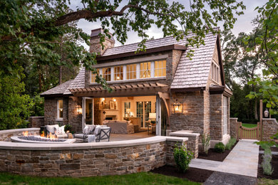 Example of a large classic backyard stone patio design in Salt Lake City with no cover and a fire pit