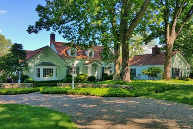 Example of a mid-sized classic white two-story wood exterior home design in New York with a shingle roof