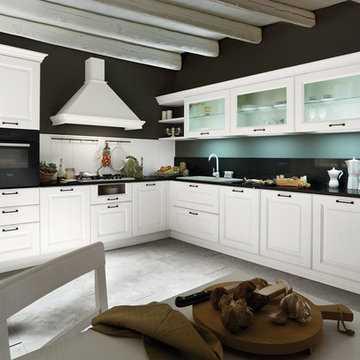 Traditional L-shaped white kitchen with black countertop