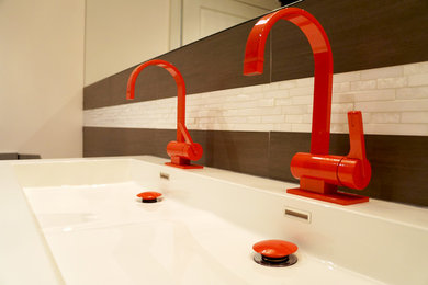 Mid-sized minimalist 3/4 brown tile, white tile and matchstick tile vinyl floor bathroom photo in Toronto with flat-panel cabinets, dark wood cabinets, a one-piece toilet, white walls, a trough sink and quartz countertops