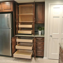 Pantry next to the refrigerator with slide draws