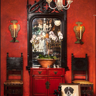 This is an example of a medium sized mediterranean formal enclosed living room in Los Angeles with red walls, dark hardwood flooring, no fireplace, no tv and brown floors.
