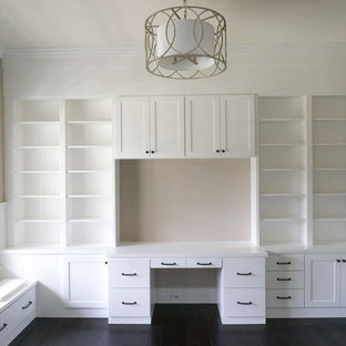 This is an example of a medium sized modern home office and library in Chicago with a reading nook, beige walls, dark hardwood flooring, no fireplace, a built-in desk and black floors.