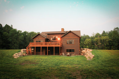 Foto de fachada de casa marrón y marrón de estilo americano de dos plantas con revestimientos combinados, tejado a dos aguas, tejado de teja de madera y tablilla