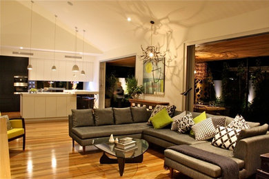 Contemporary living room in Adelaide with white walls and medium hardwood floors.