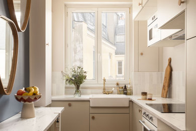 Inspiration for a small scandinavian single-wall separate kitchen in Paris with an undermount sink, marble benchtops, white splashback, ceramic splashback, stainless steel appliances, slate floors, red floor and white benchtop.