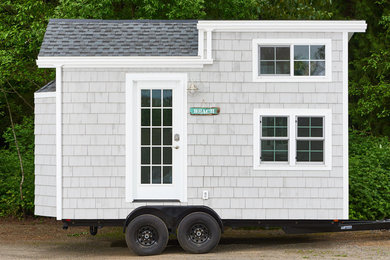 Beach style gray two-story wood gable roof photo in Portland