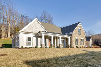 Inspiration for a large craftsman beige two-story concrete fiberboard exterior home remodel in Other with a hip roof