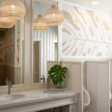 One of six renovated club restrooms — a double vanity beneath woven pendants and