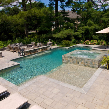 Pool and Spa with 360 degree spa spillover, two sun shelfs, raised stone wall wi
