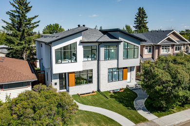 Minimalist white two-story stucco exterior home photo in Calgary